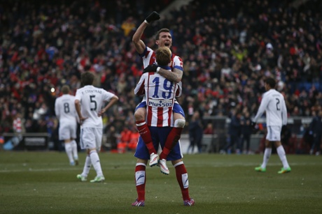 Mandzukic celebrates, it's an emphatic victory for Atletico over their local rivals.