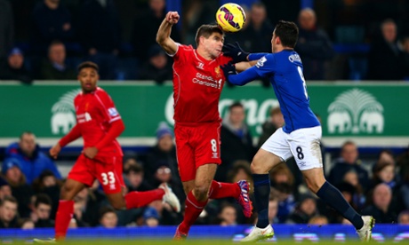 Steven Gerrard tussles with Bryan Oviedo of Everton.
