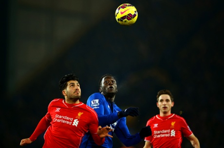 Emre Can of Liverpool jumps for the ball with Romelu Lukaku of Everton.