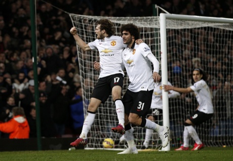 Daley Blind celebrates scoring his goal with Marouane Fellaini.