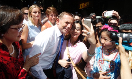 Prime Minister Tony Abbott together with his wife Margie and daughter Bridget pose for pictures with citizens during a visit to Chinatown of Sydney, Australia, 08 February 2015.