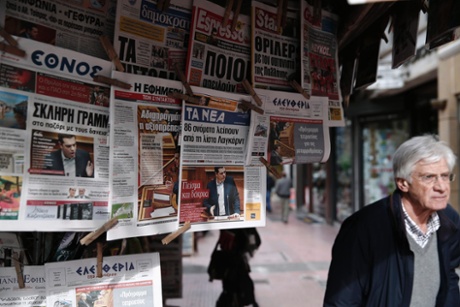 Greek Prime Minister Alexis Tsipras is pictured on newspapers at a kiosk in Athens February 9, 2015.