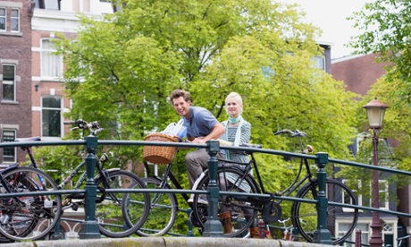 Couple on bike, canal, Amsterdam