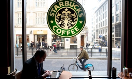 City worker on laptop in Starbucks coffee shop Monument London