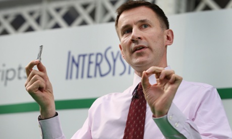 Health Secretary Jeremy Hunt holds up a memory stick containing a record of a whole human genome as he speaks at the UK e-Health Week event