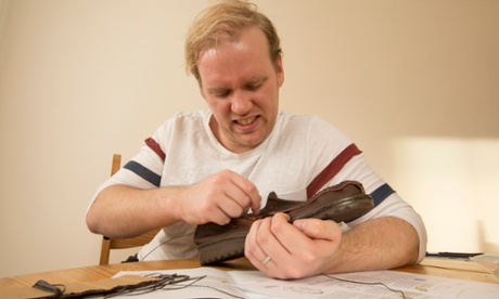 Stuart grapples with his shoe.