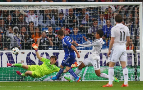 Klaas Jan Huntelaar shoots past goalkeeper Iker Casillas to score their second goal.