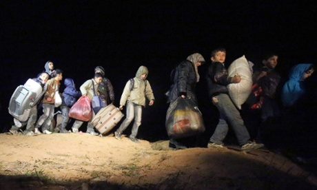 Refugees fleeing the conflict in Syria arrive at the Jordanian border at a safe crossing point.