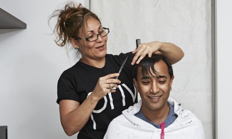 Rhik Samadder sits on his suitcase while Tania cuts his hair.