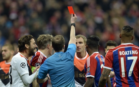 Referee William Collum shows the red card to Shakhtar Donetsk's defender Olexandr Kucher.