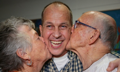 Al-Jazeera journalist Peter Greste is kissed by his mother Lois (L) and father Juris (R) upon his arrival at Brisbane's international airport.