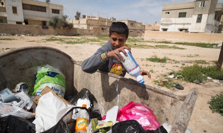Syrian refugee Ahmed Jabra, 15 who collects used cans and plastics to sell for recycling as well as discarded bread to sell as animal feed to help support his family. Photo Sean Smith