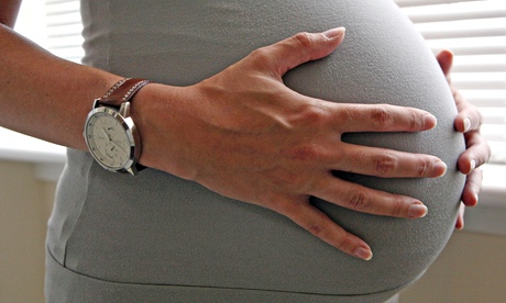 Pregnant woman holding stomach