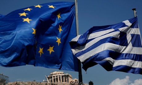 An EU and a Greek flag fly in front of the ancient Parthenon temple, in Athens