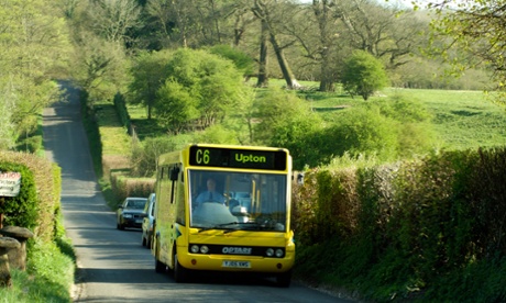 Single deck bus travelling along a country lane in Hampshire