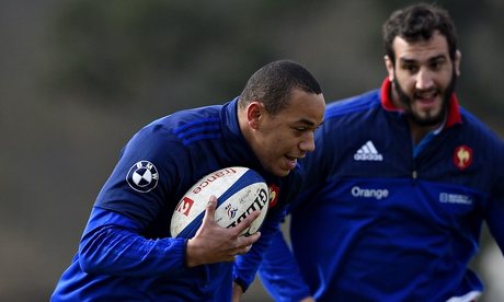 France's winger Gael Fickou (L) runs wit