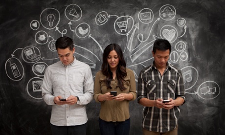 people holding phones with blackboard behind