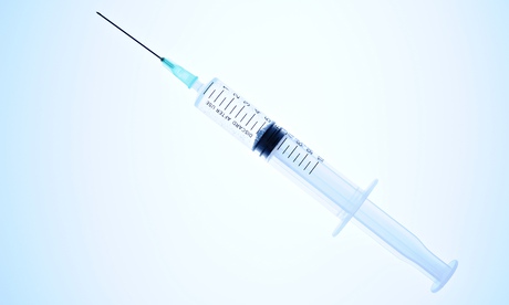 Syringe on blue background