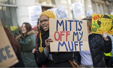 Campaigner with 'mitts off my muff' placard