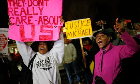 Protesters demonstrate across the street from the Ferguson Police Department in Ferguson, Missouri, on Thursday.