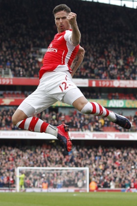 Olivier Giroud dances in the air after scoring for Arsenal