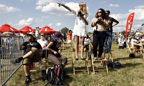 Spectators watch an airplane performance at the Radom Air Show at an airport in Radom