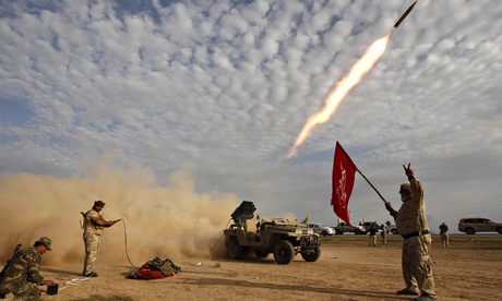 Shia fighters launch a rocket during clashes with Isis militants on the outskirts of al-Alam on 8 March. Photograph: Thaier Al-Sudani/Reuters