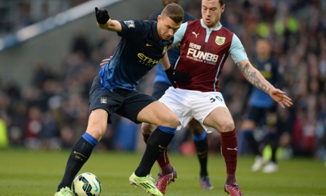 Manchester City's Edin Dzeko with Burnley's Ashley Barnes.