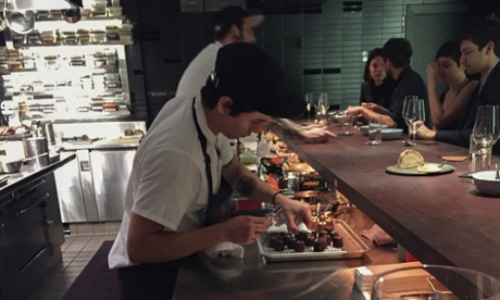 A chef at Chang's Momofuku Ko prepares a dessert.