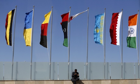 An Egyptian security official uses his phone outside the venue for the Egyptian Economic Development Conference.