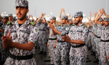Members of the Saudi security forces take part in a military parade.