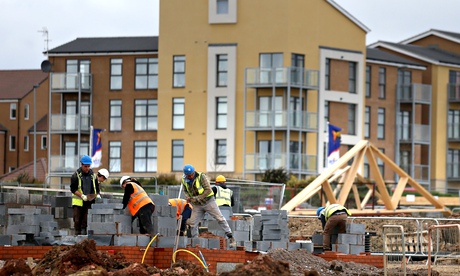 Construction workers building houses