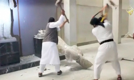 Men use sledgehammers on a statue in a museum at a location said to be Mosul, northern Iraq, in this still image taken from a video published by Islamic State