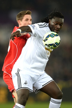 Bafetibis Gomis and Joe Allen compete.