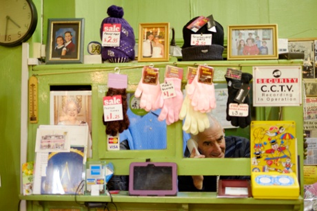 Michael Albert speaks on the telephone at Blustons clothes shop in Kentish Town.