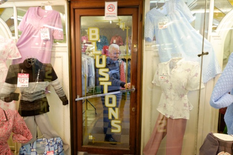 Shutting up shop: Michael Albert closes the door of Blustons clothes.