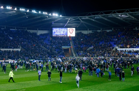 Reading fans run onto the pitch after the game.