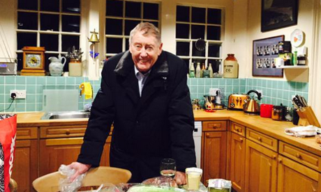 Austin Mitchell smiling his kitchen