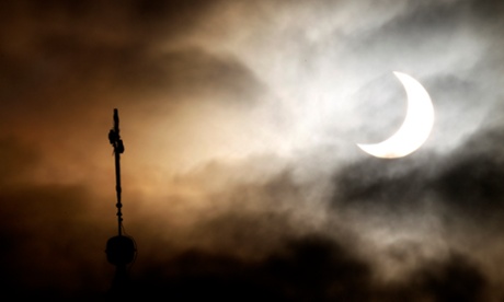 A partial solar eclipse is visible over the city of Warsaw on January 4, 2011