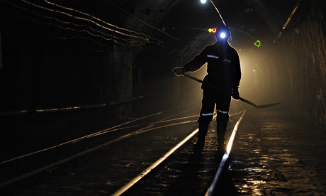 A miner walks along tracks used for transporting coal in Xiaoyi, Shanxi province, China.