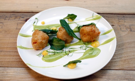 Cubes of beer-battered halloumi, with smears of mushy pea emulsion and lemon curd, and scattered sea herbs.
