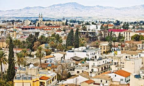 Rooftops and trees of Nicosia, Cyprus, with mountains behind