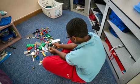 One of the children at Clayfields House plays with Lego in his room.