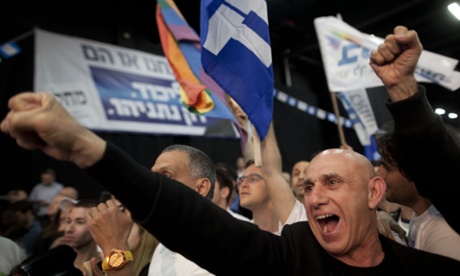 Supporters of Binyamin Netanyahu celebrate as election results come in at his election campaign headquarters. However, it's not yet clear whether he has won.