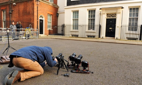 A photographer adjusts a remote camera outside 11 Downing Street