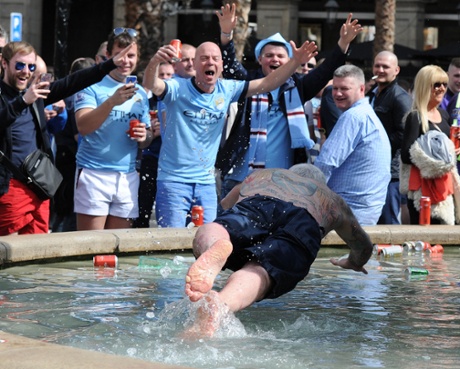 A Manchester City fan dives into the fountain in Placa Reial square, earlier.