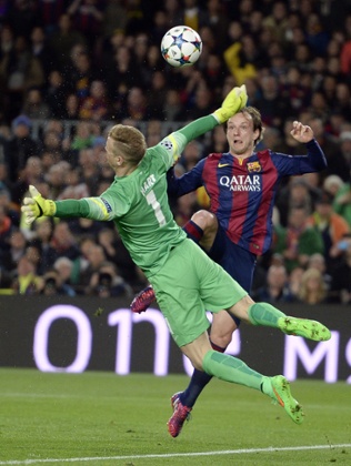 Barcelona's Ivan Rakitic lofts the ball over Joe Hart to open the scoring.