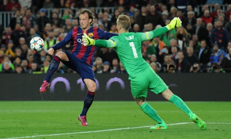 Barcelona's Ivan Rakitic scores the opening goal by chipping Manchester City's Joe Hart.