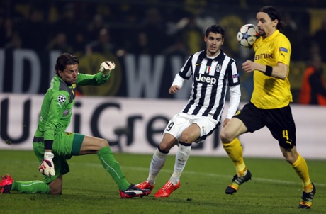 Dortmund's Neven Subotic blocks the ball after it  was saved by Dortmund's keeper Roman Weidenfeller from Alvaro Morata's shot.