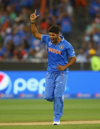 Umesh Yadav celebrates after taking the wicket of Tamim Iqbal